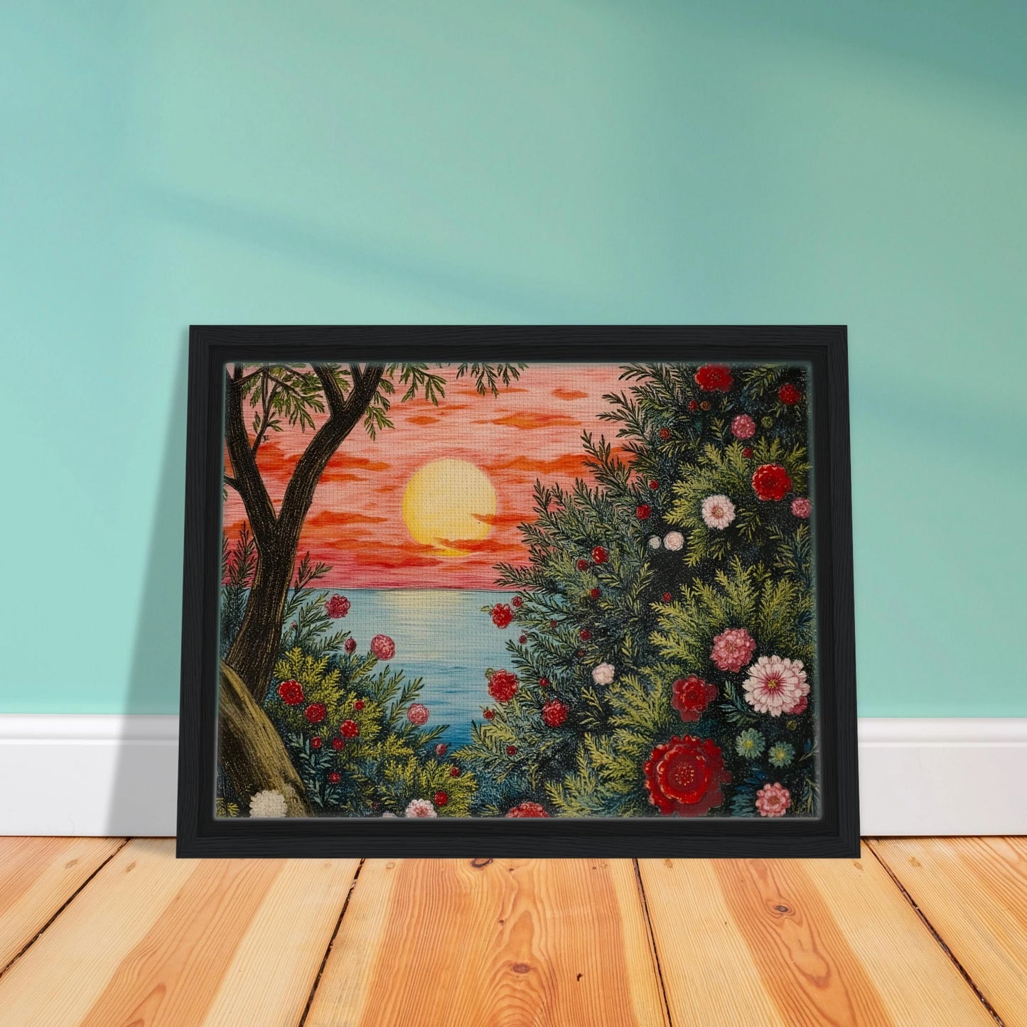 A vivid sunset over the ocean framed by lush bushes filled with red, pink, and white flowers.