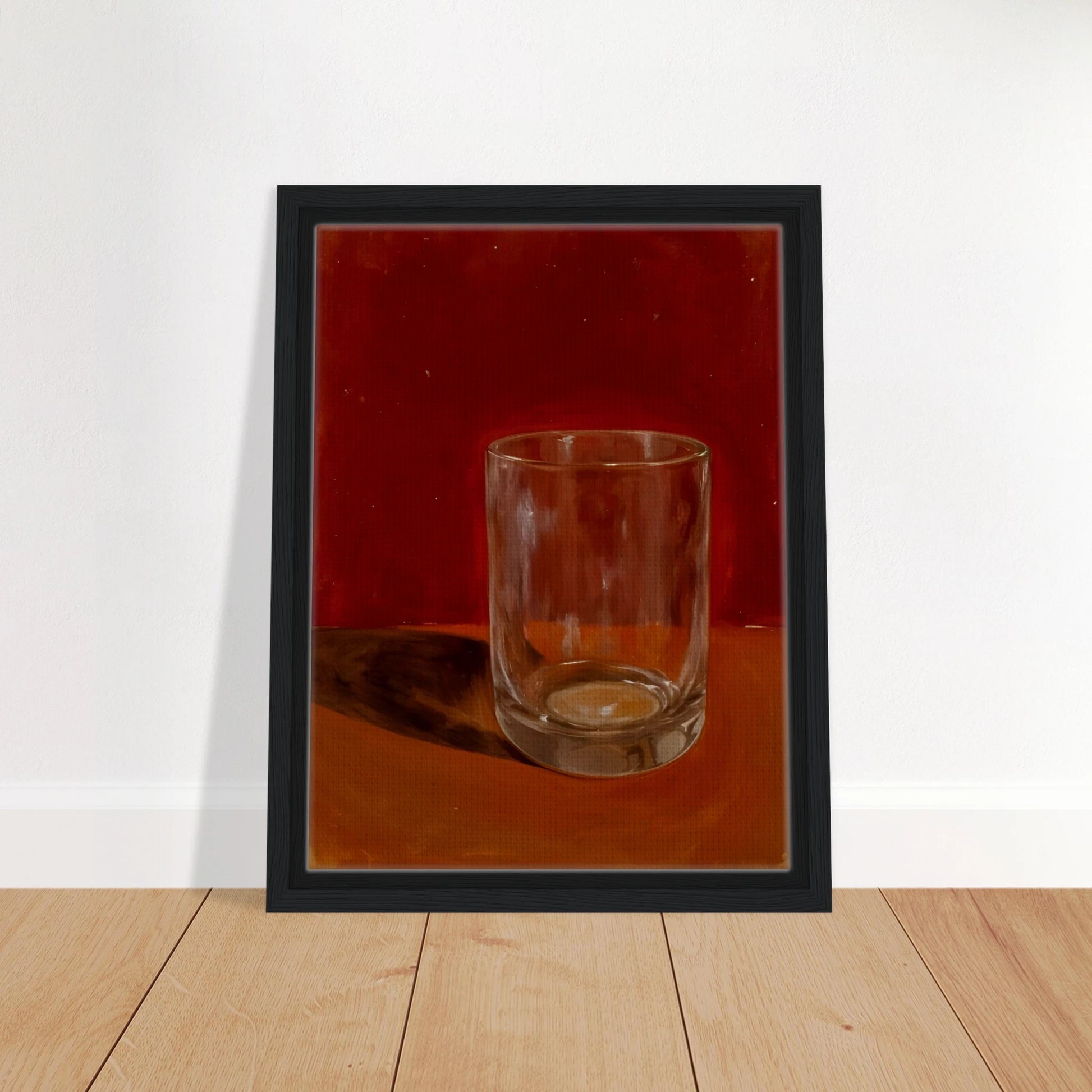 Transparent drinking glass casting a soft shadow on a warm orange and red background.