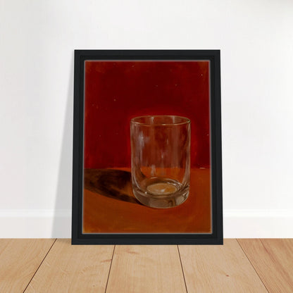 Transparent drinking glass casting a soft shadow on a warm orange and red background.