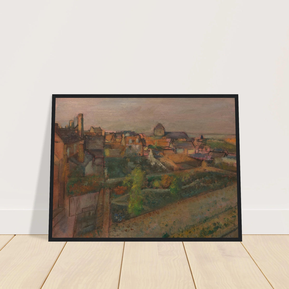 A high view of Saint-Valéry-sur-Somme with rooftops, gardens, and distant water under a pale sky.