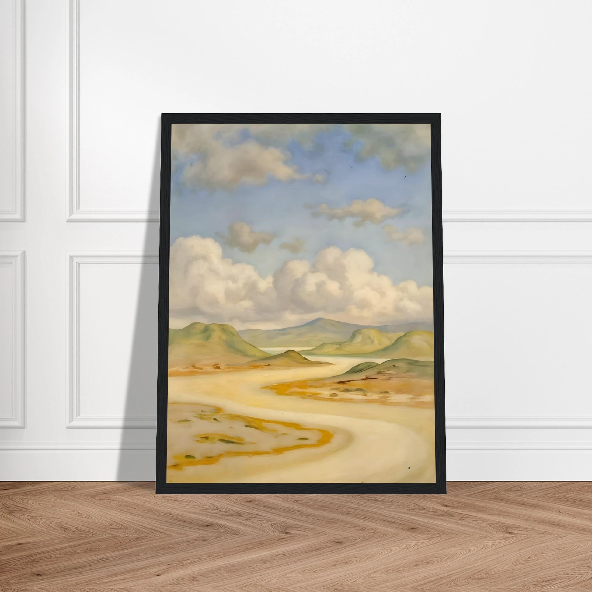 Soft clouds drift above pale hills, sandy curves, and quiet water under a blue sky.