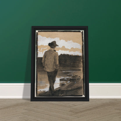 Young man in a hat stands by a riverbank, looking toward clouds and distant water