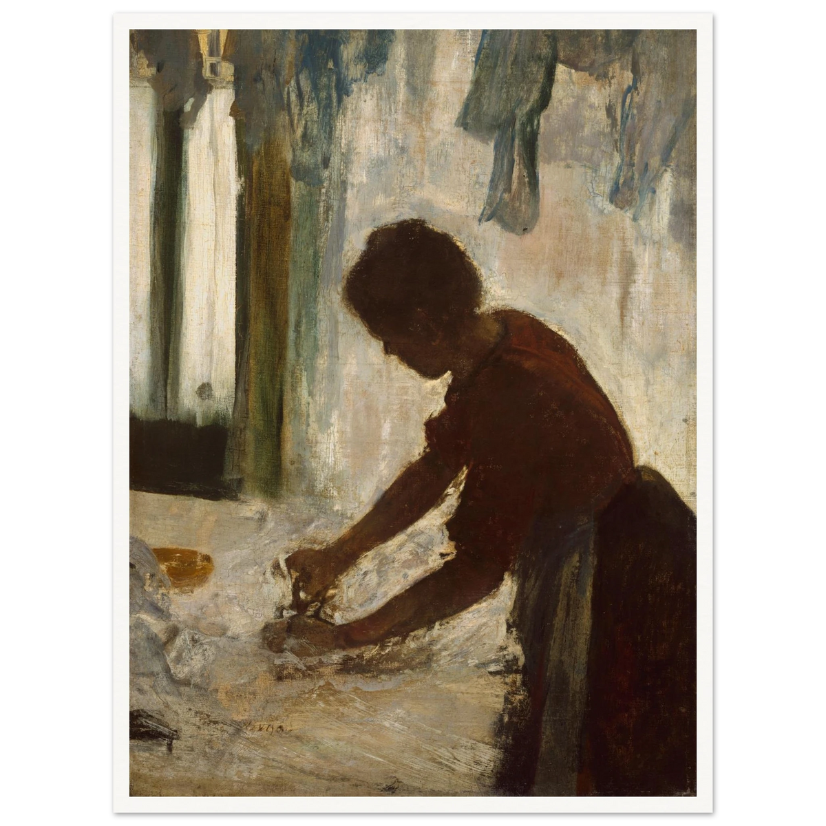 A woman leans over a table ironing white fabric, silhouetted against a softly lit laundry interior.
