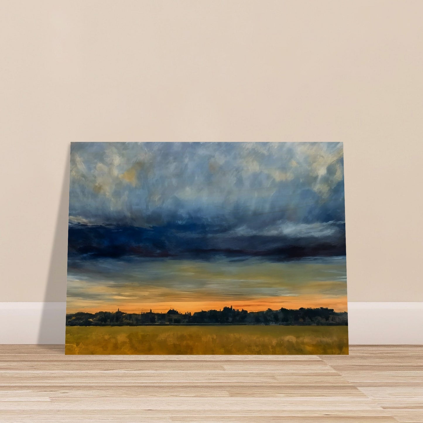 A distant cityscape under a dramatic sky at dusk, with the horizon glowing orange and a vast field in the foreground.