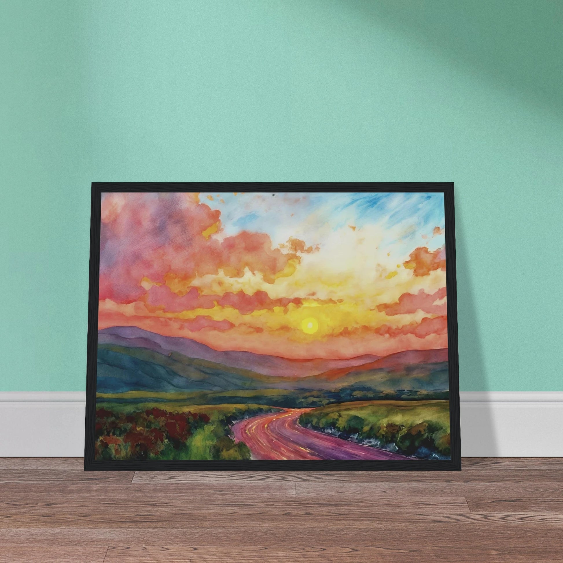 Vibrant watercolor landscape of a winding road through rolling hills beneath a glowing sunset sky filled with pink, gold, and blue clouds.