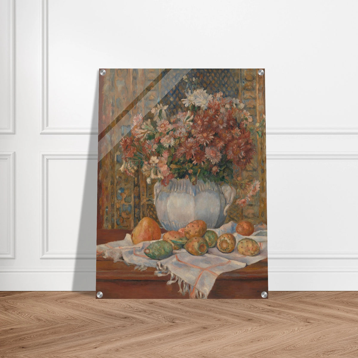 Autumn flowers in a blue vase with prickly pears and cloth on a table before a patterned screen.