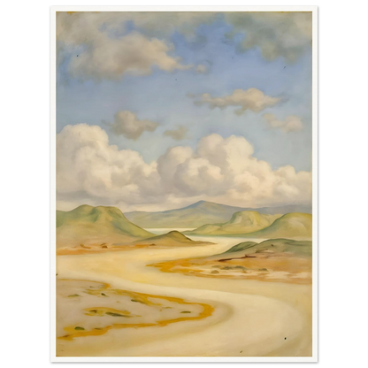 Soft clouds drift above pale hills, sandy curves, and quiet water under a blue sky.
