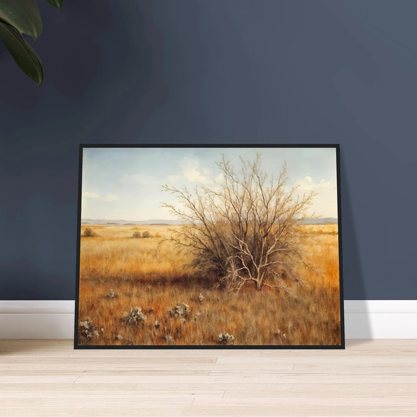 A golden-brown field stretches into the distance under a pale blue sky, with a single dry bush standing in quiet solitude.