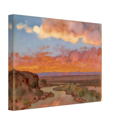 Soft desert river winding beneath glowing orange and pink sunset clouds, with distant plains and muted cliffs in a serene landscape.