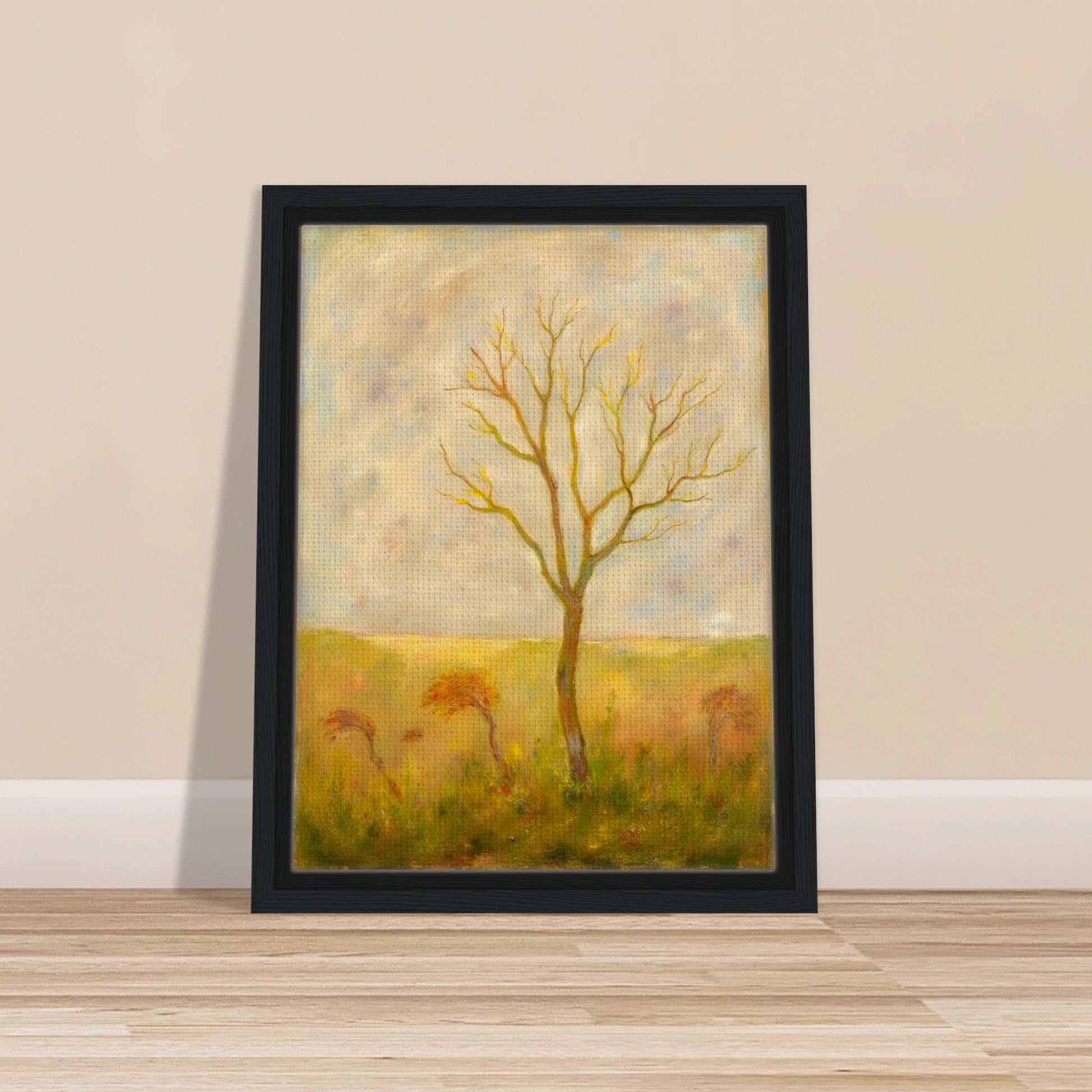 A lone tree stands tall in a golden meadow under a pale sky, its bare branches reaching gracefully toward the light.