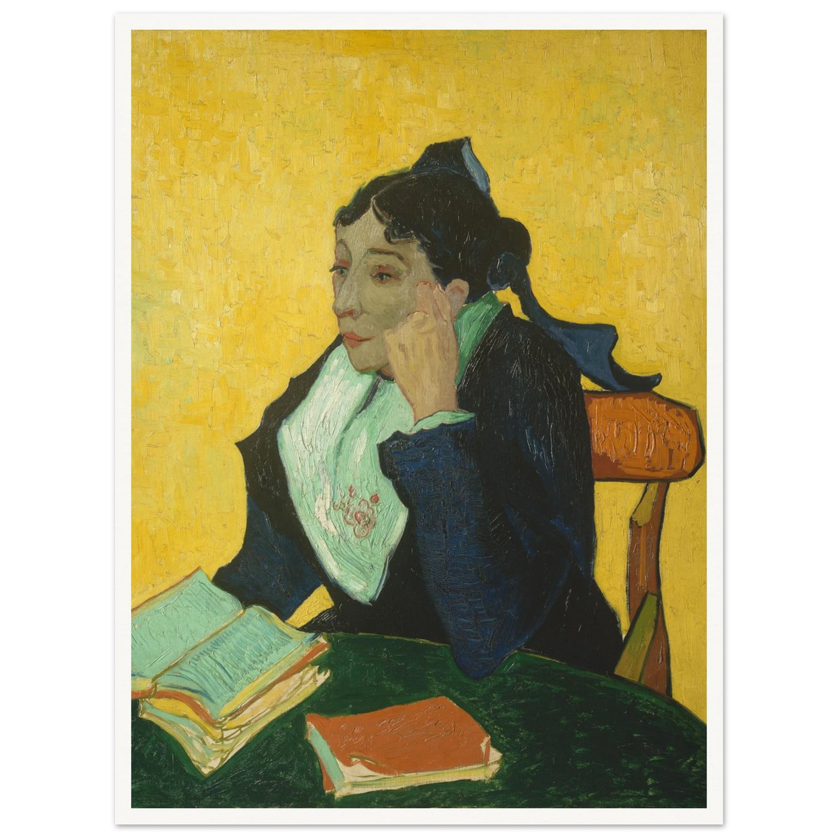 Woman in black and green sits at a table with open books against a vivid yellow background.