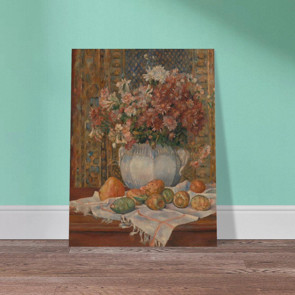 Autumn flowers in a blue vase with prickly pears and cloth on a table before a patterned screen.