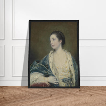 Young woman in a blue robe with fur trim poses against a dark green background