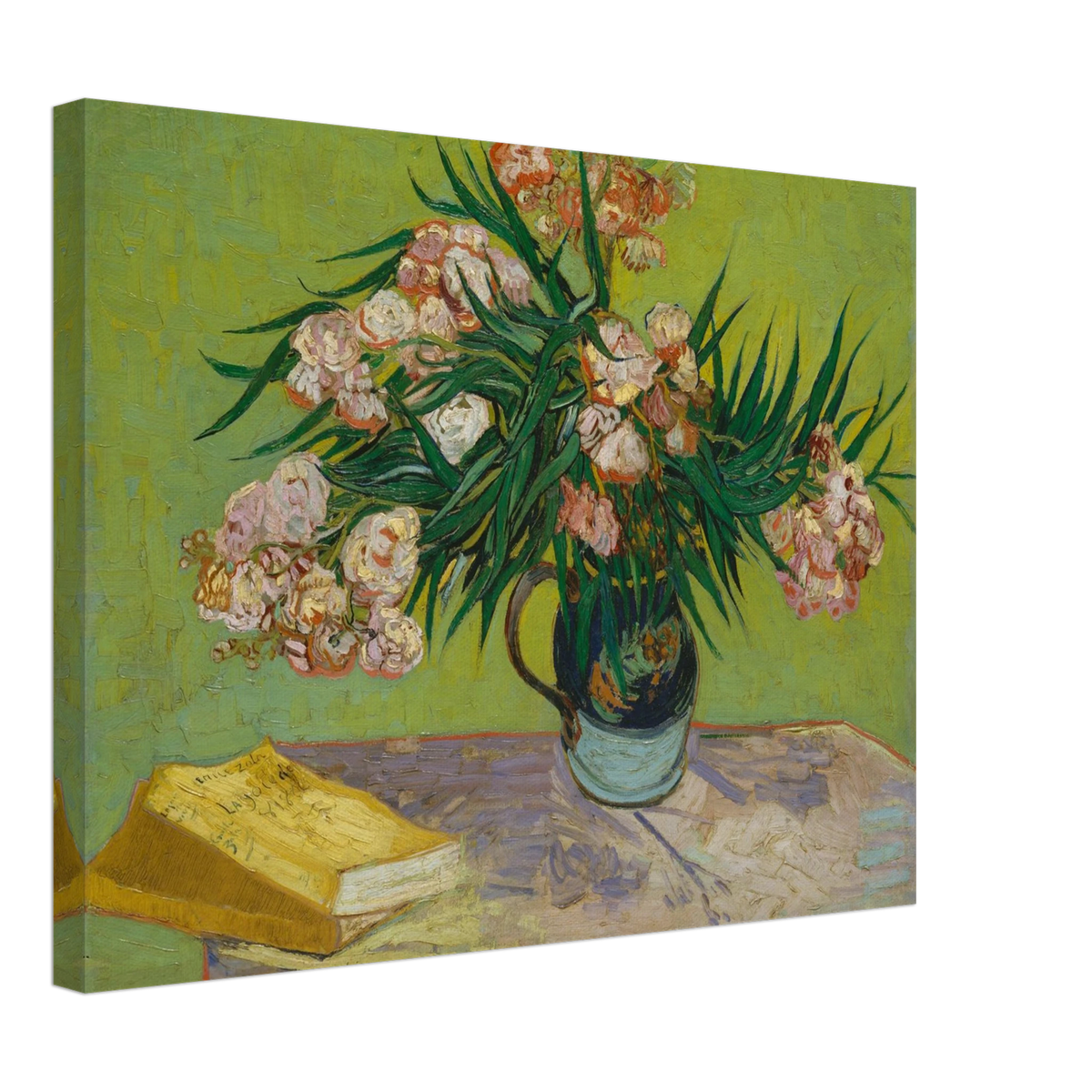 Pink oleanders bloom in a vase beside a yellow book on a green table.