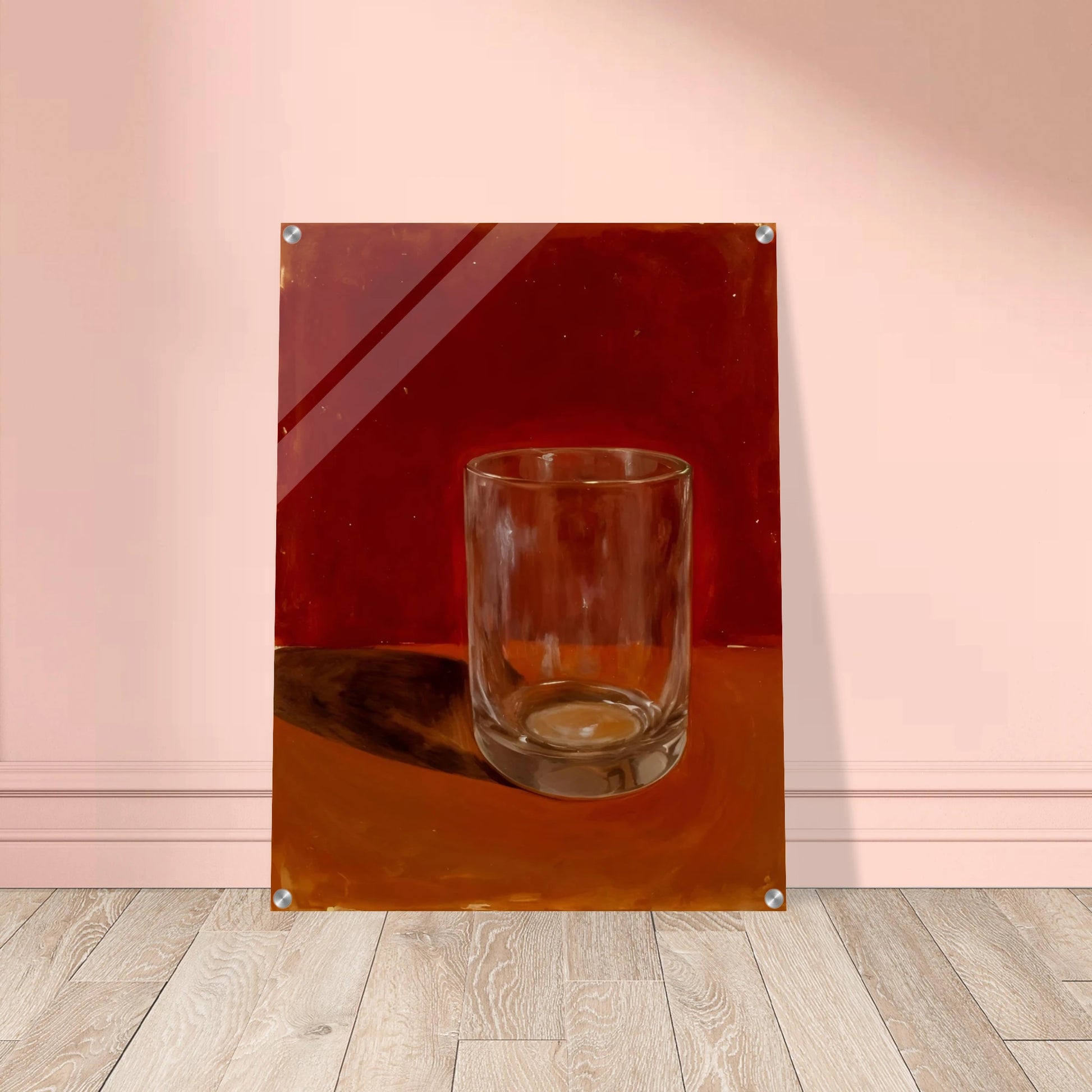Transparent drinking glass casting a soft shadow on a warm orange and red background.