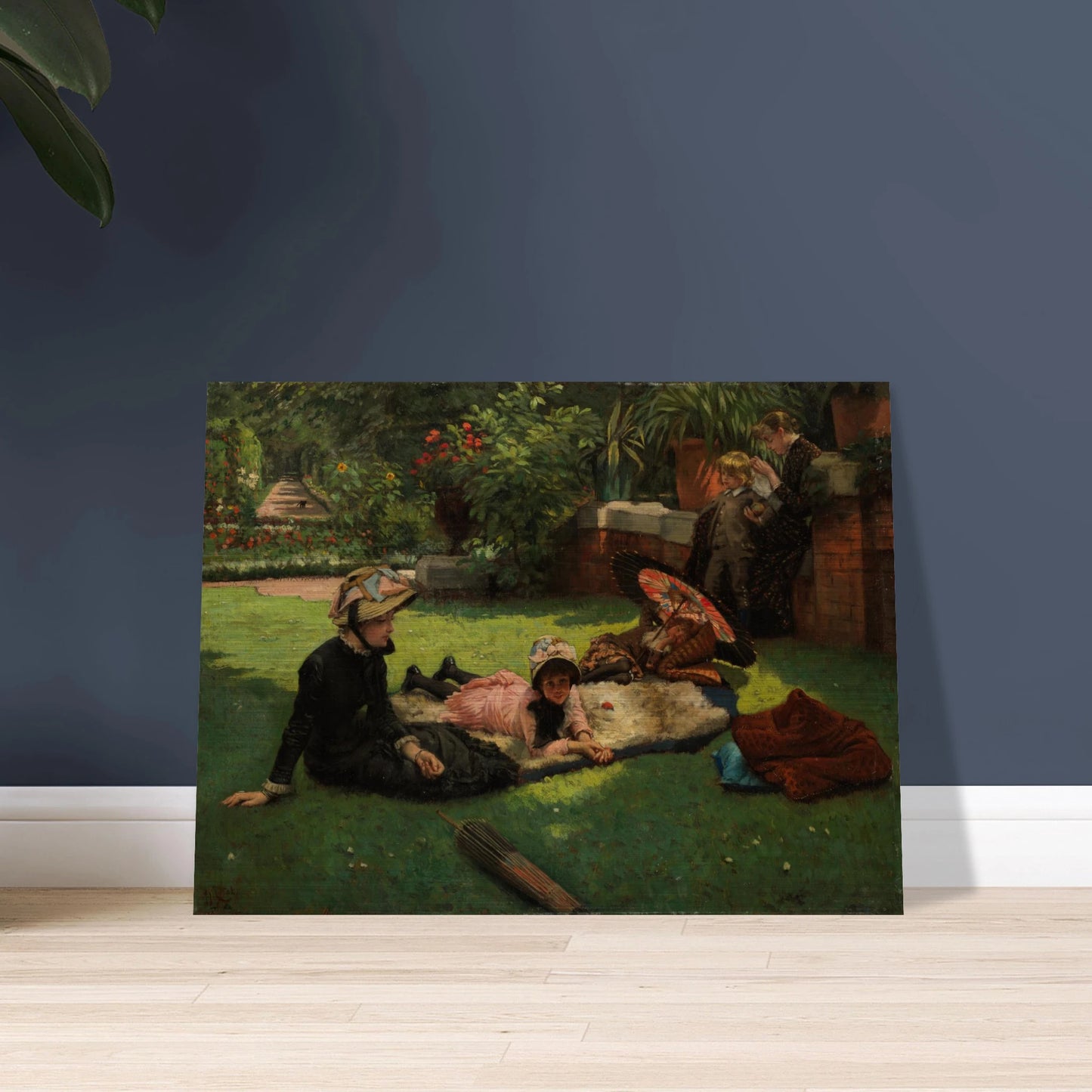 Children and women lounge in a garden with a colorful parasol under bright sunlight