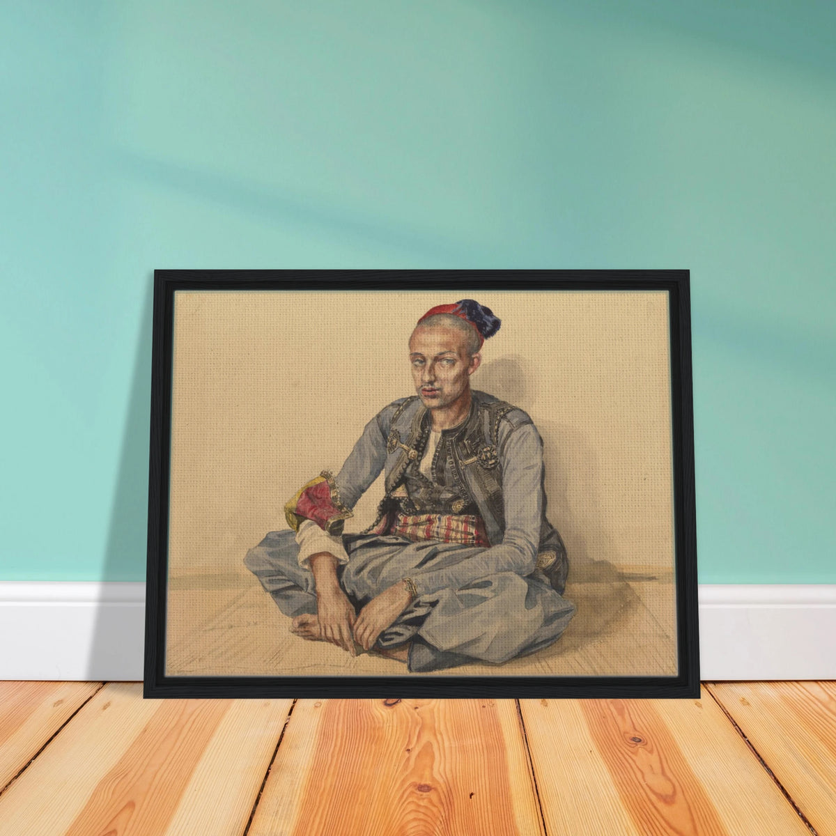 Seated artisan from Algiers in blue robes and a red cap, wearing a patterned sash and ornate accessories.