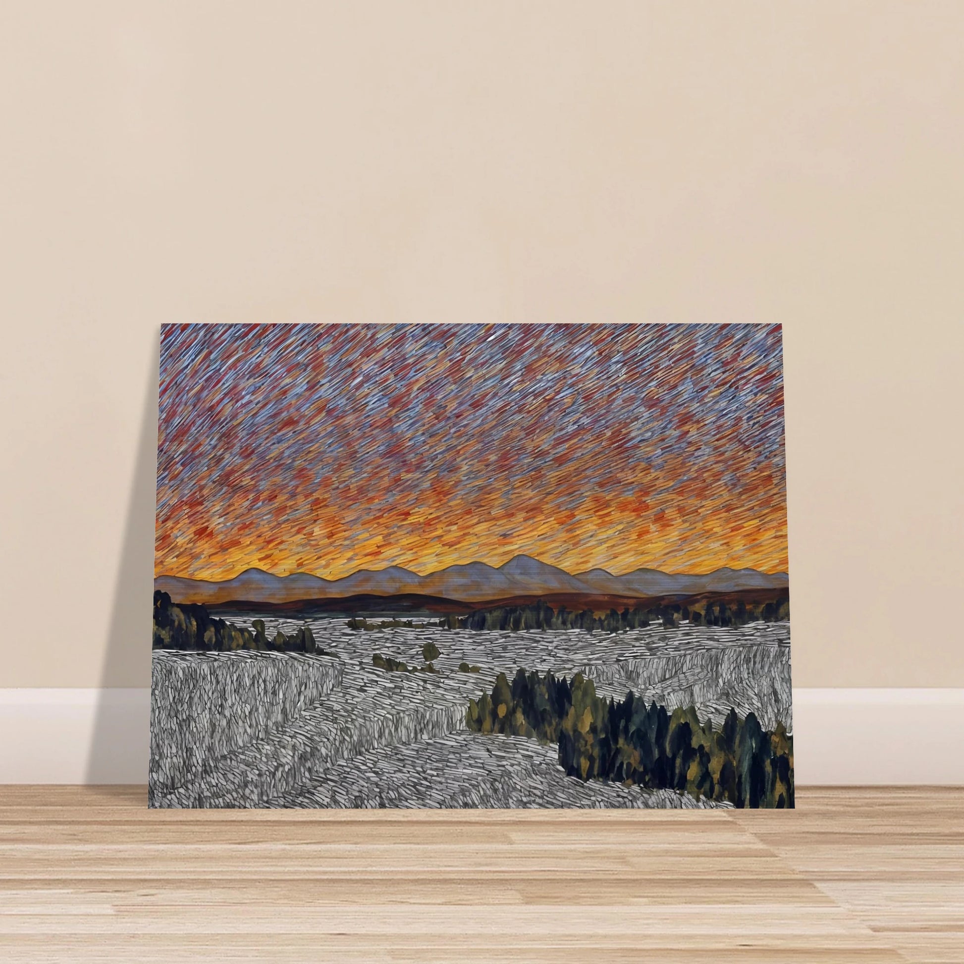 Vibrant orange sunset over distant mountains with textured sky and patterned fields in the foreground.