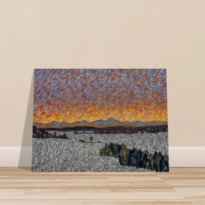 Vibrant orange sunset over distant mountains with textured sky and patterned fields in the foreground.