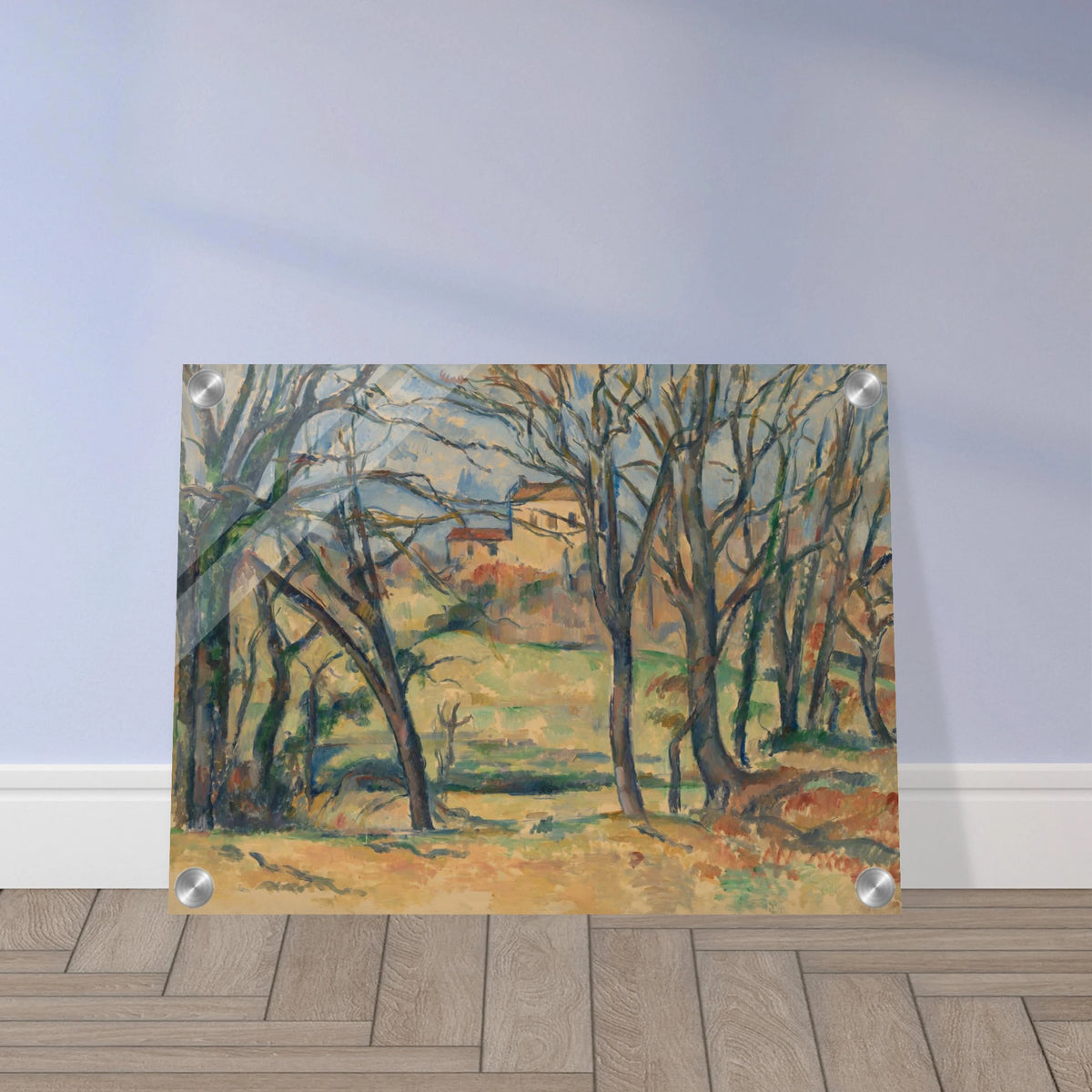 Bare trees frame yellow houses and fields in a softly painted countryside landscape.