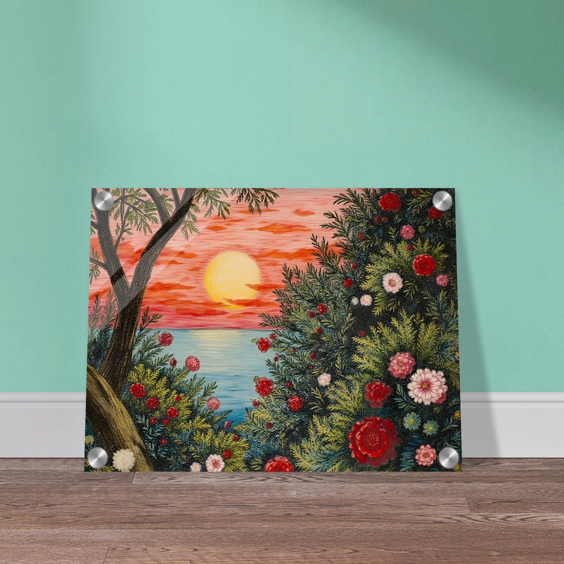 A vivid sunset over the ocean framed by lush bushes filled with red, pink, and white flowers.