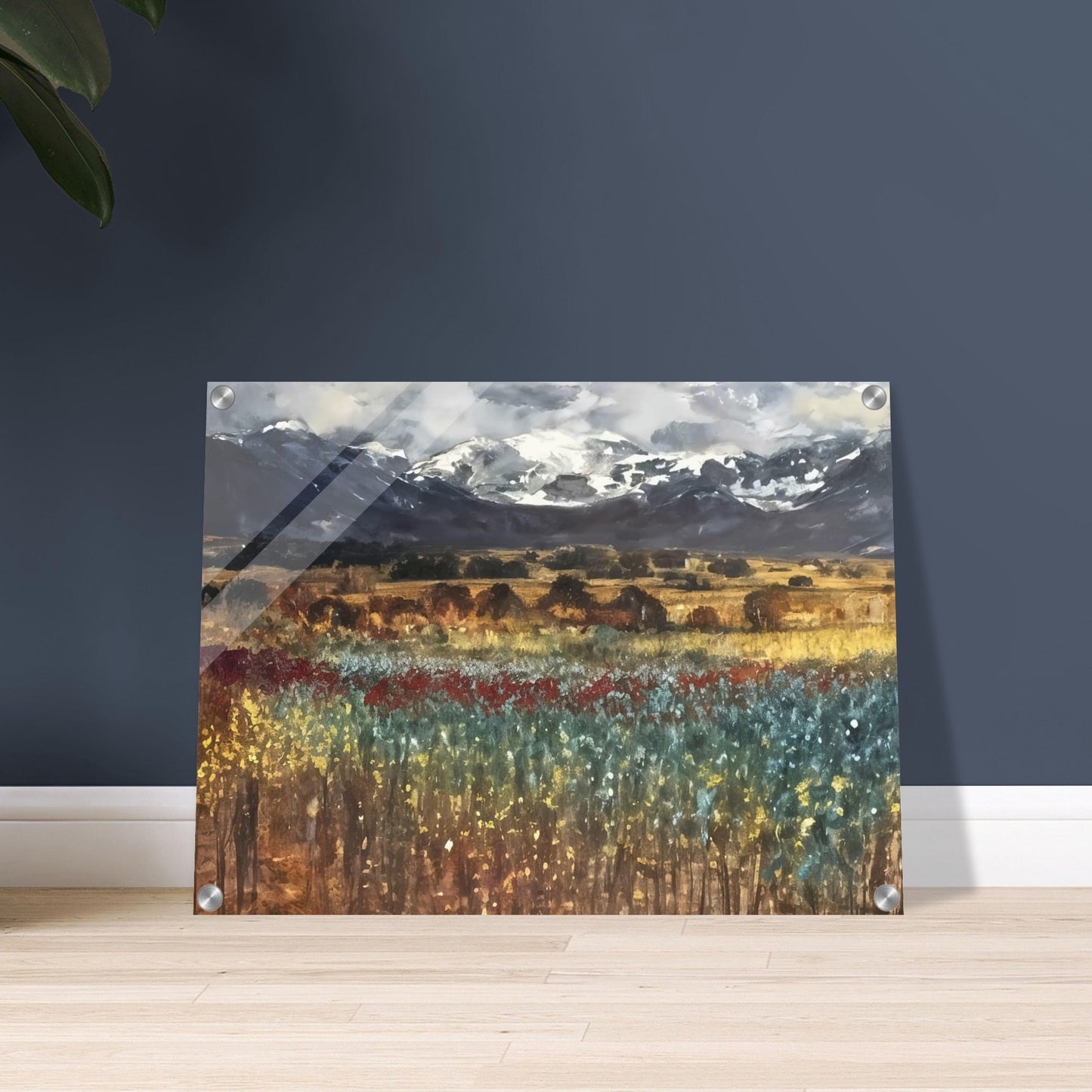 Expansive landscape with vibrant fields of flowers in red, yellow, and blue hues, framed by distant snow-capped mountains and a dramatic sky.