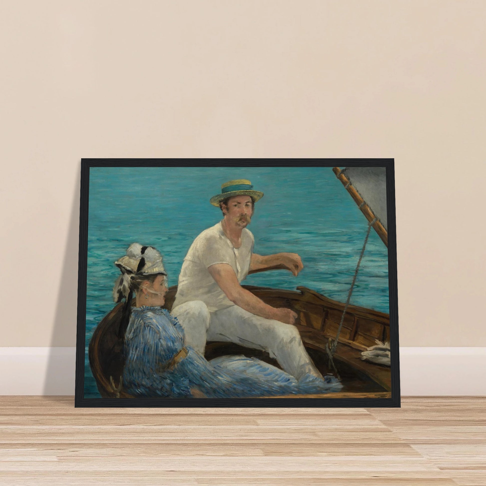 Man and woman sit in a small boat on bright blue water under a gray sail