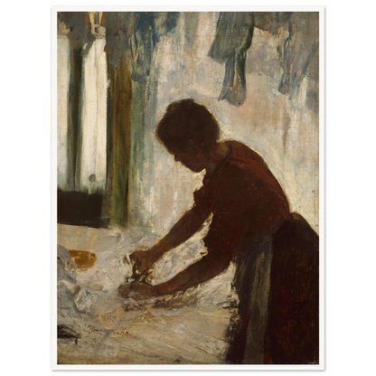 A woman leans over a table ironing white fabric, silhouetted against a softly lit laundry interior.