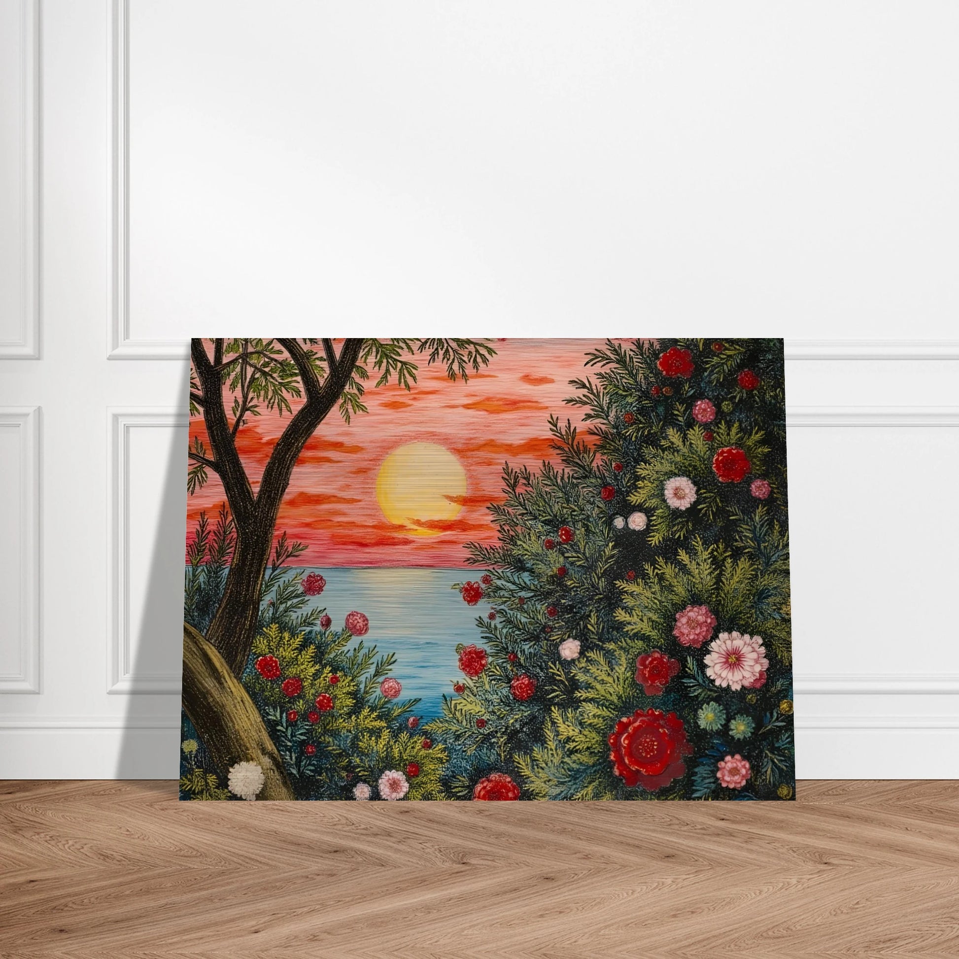 A vivid sunset over the ocean framed by lush bushes filled with red, pink, and white flowers.