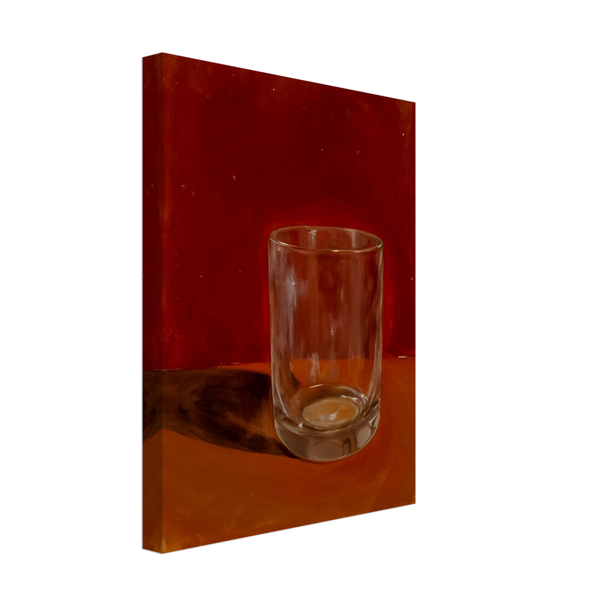 Transparent drinking glass casting a soft shadow on a warm orange and red background.