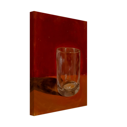 Transparent drinking glass casting a soft shadow on a warm orange and red background.