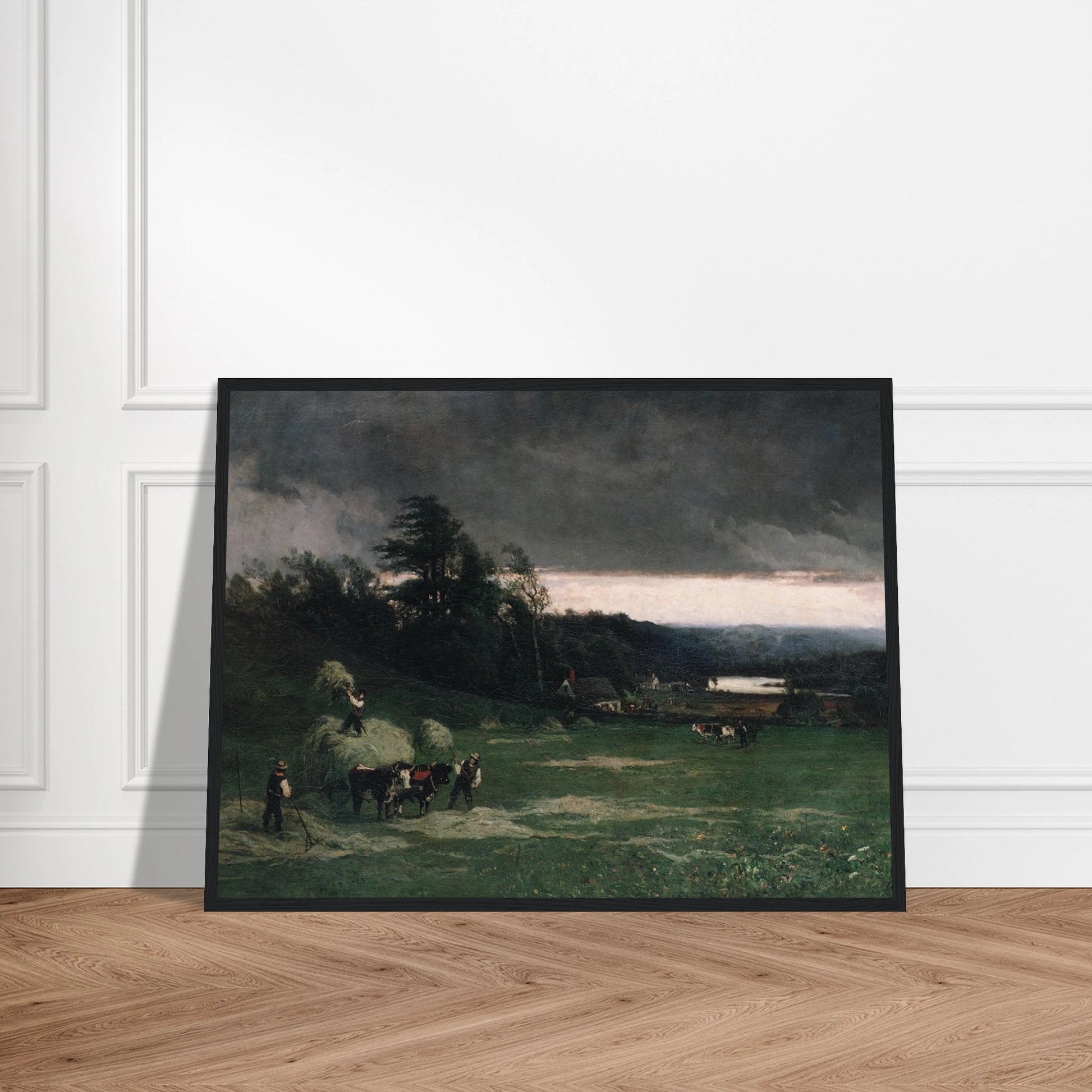 Workers gather hay in a green field under dark storm clouds