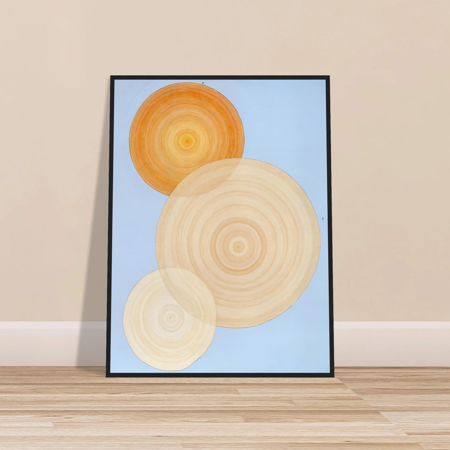 Three overlapping concentric circles in warm orange and beige tones float on a soft blue background like suns in serene orbit.