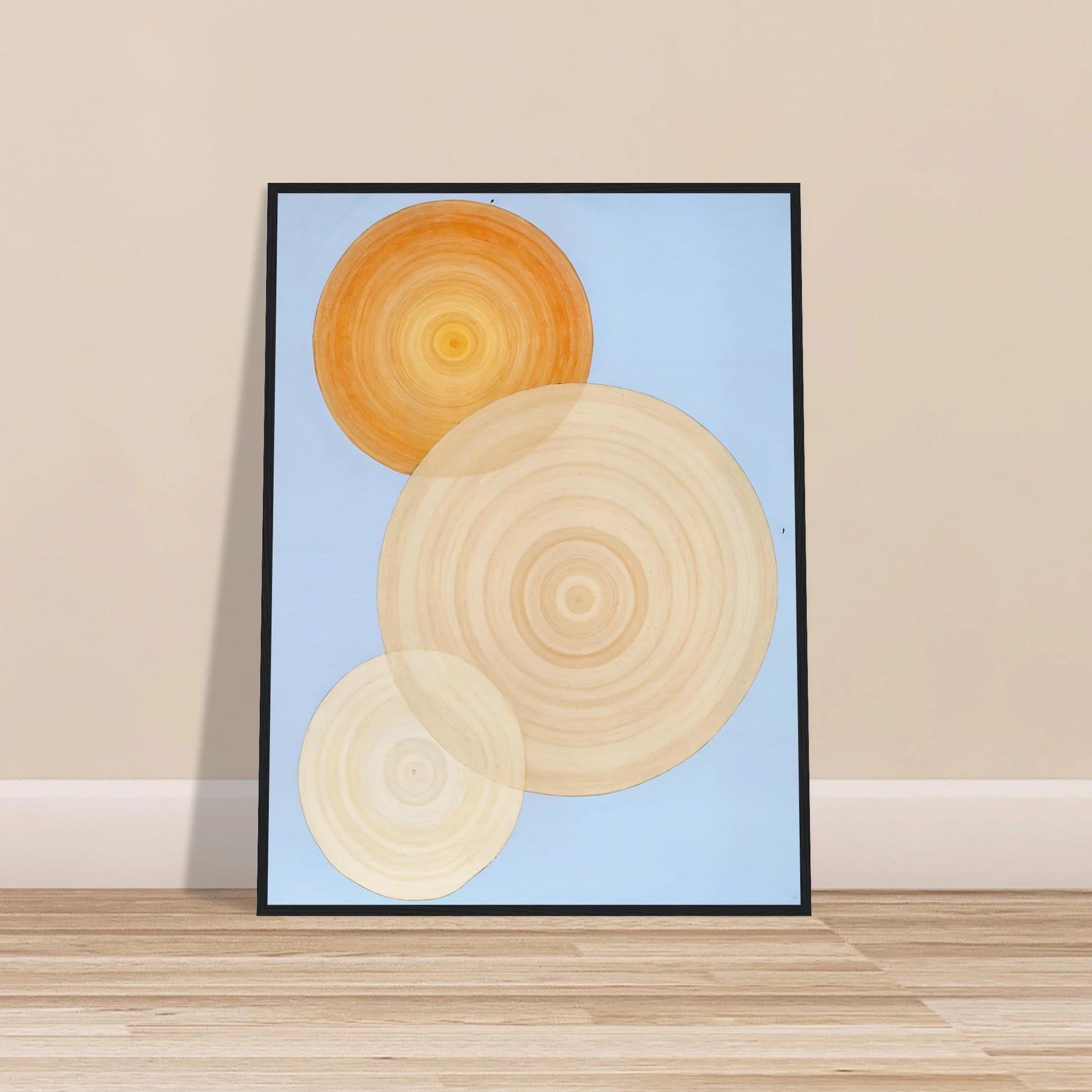 Three overlapping concentric circles in warm orange and beige tones float on a soft blue background like suns in serene orbit.