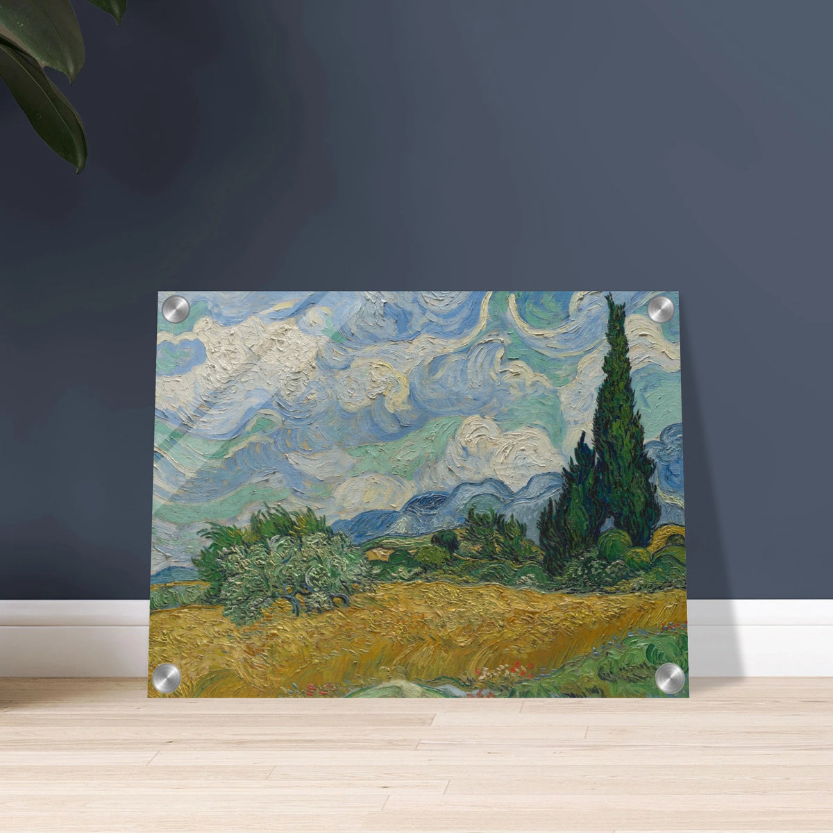 Golden wheat field and dark cypress trees beneath swirling blue-and-white clouds in a vivid Provençal landscape.