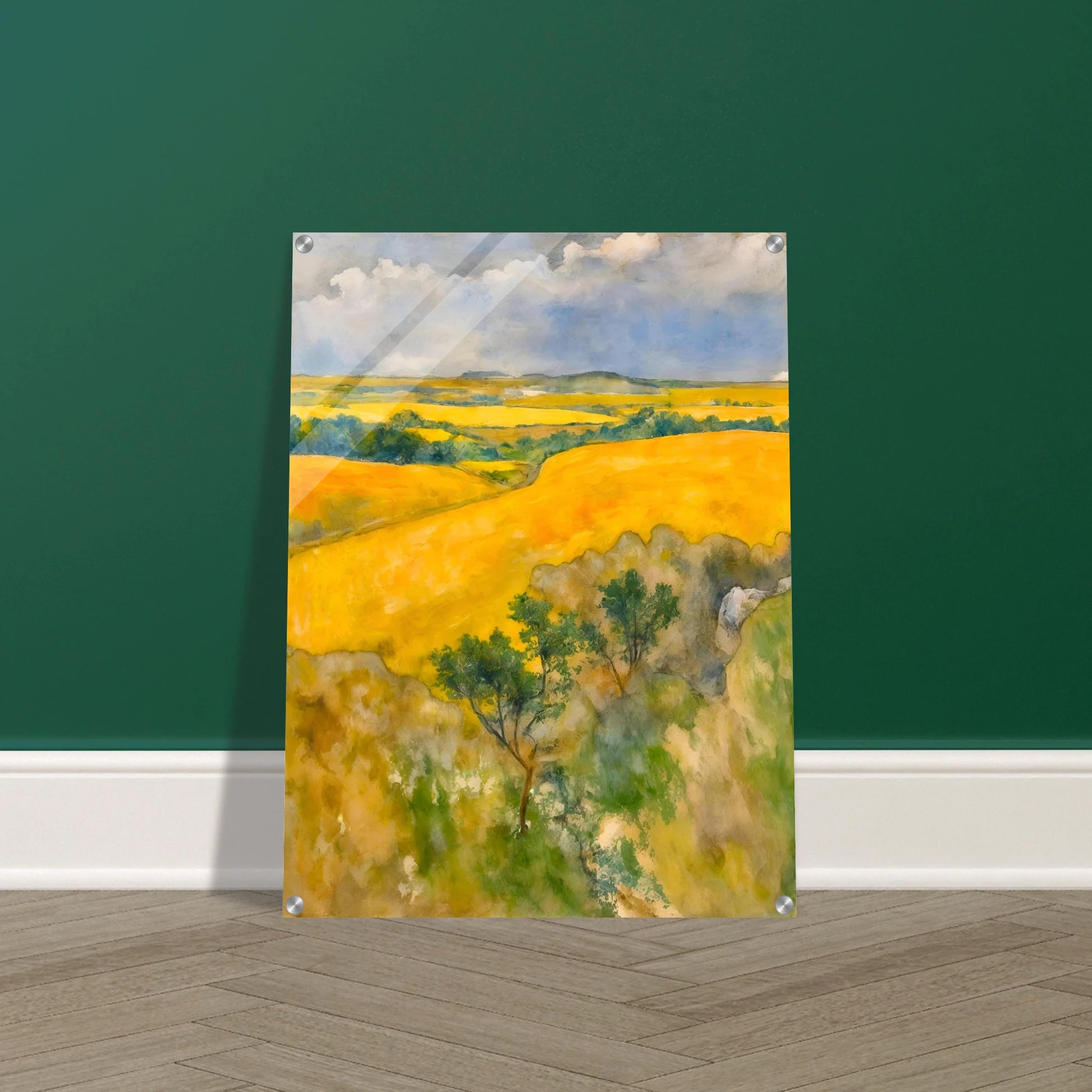 Golden fields stretch across rolling hills under a blue and cloudy sky, with trees dotting the lush summer landscape.