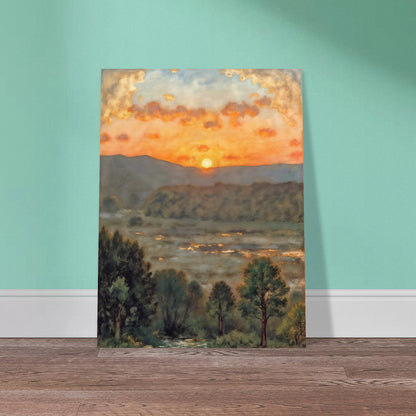 A glowing sunset over misty hills and a river valley, where the sky burns in orange light above soft green trees.