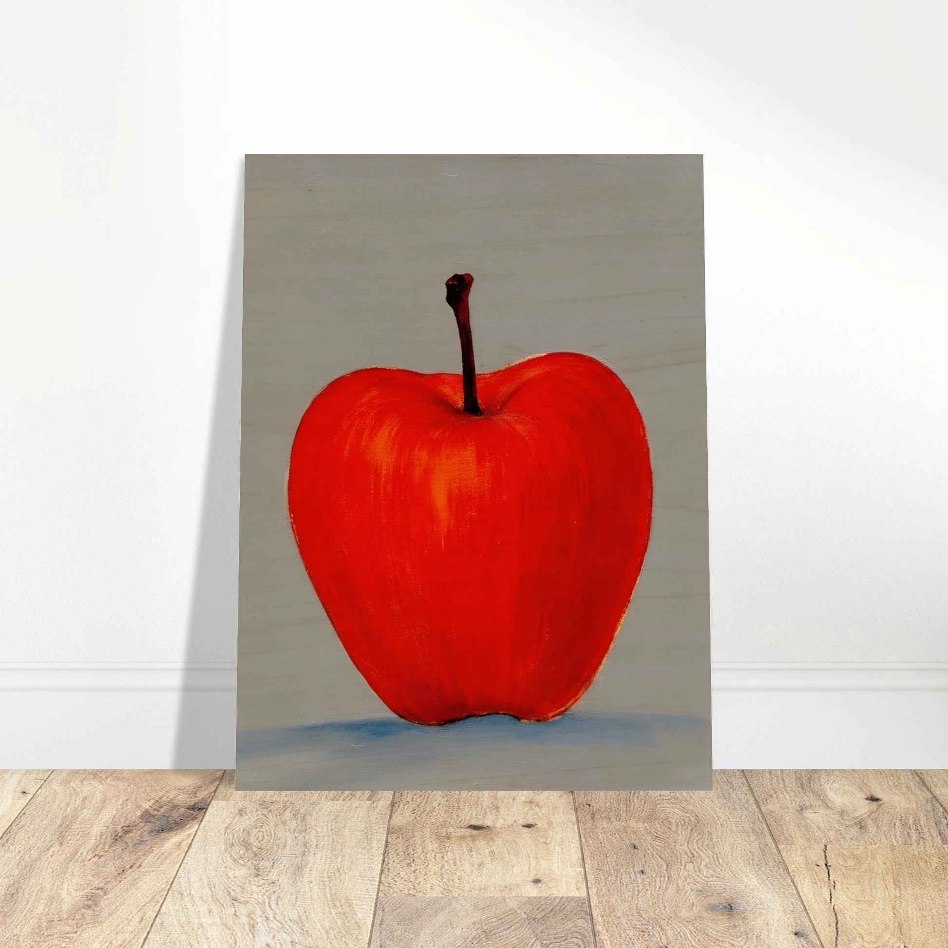 A vivid red apple stands alone against a muted gray backdrop, its glowing form balancing simplicity, boldness, and quiet elegance.