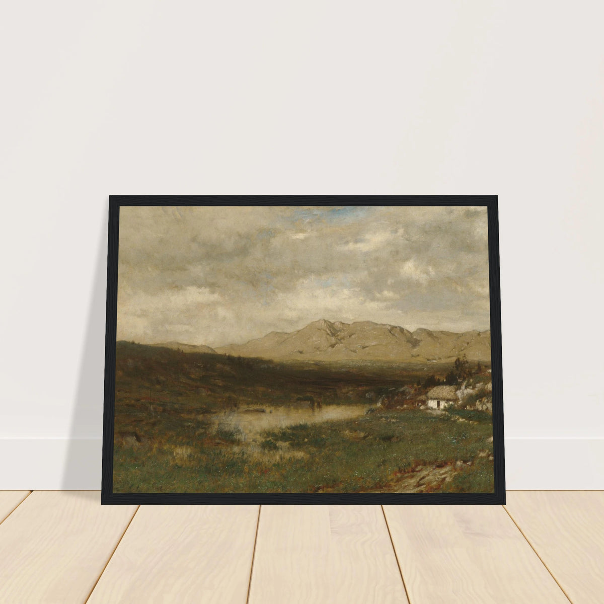 A rural cottage sits below distant mountains beneath a broad, cloudy sky in the Irish countryside.