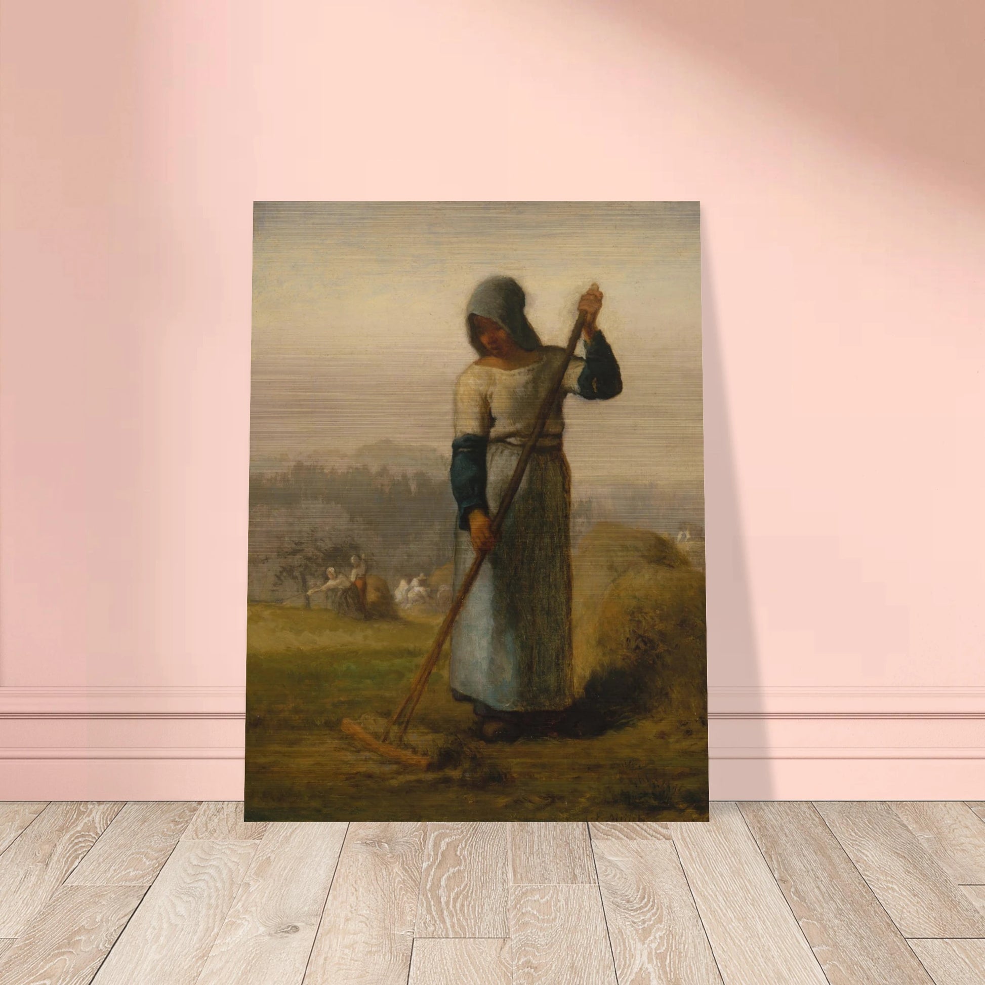 A peasant woman holds a wooden rake beside a haystack as farm workers gather hay in a distant field.