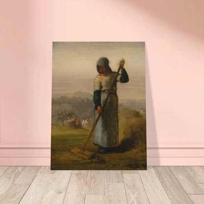 A peasant woman holds a wooden rake beside a haystack as farm workers gather hay in a distant field.