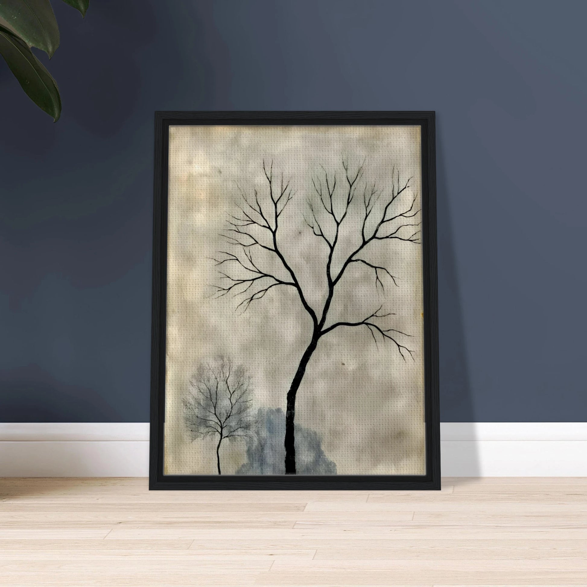 Two leafless trees stand silhouetted against a misty gray sky, evoking a quiet, contemplative atmosphere.