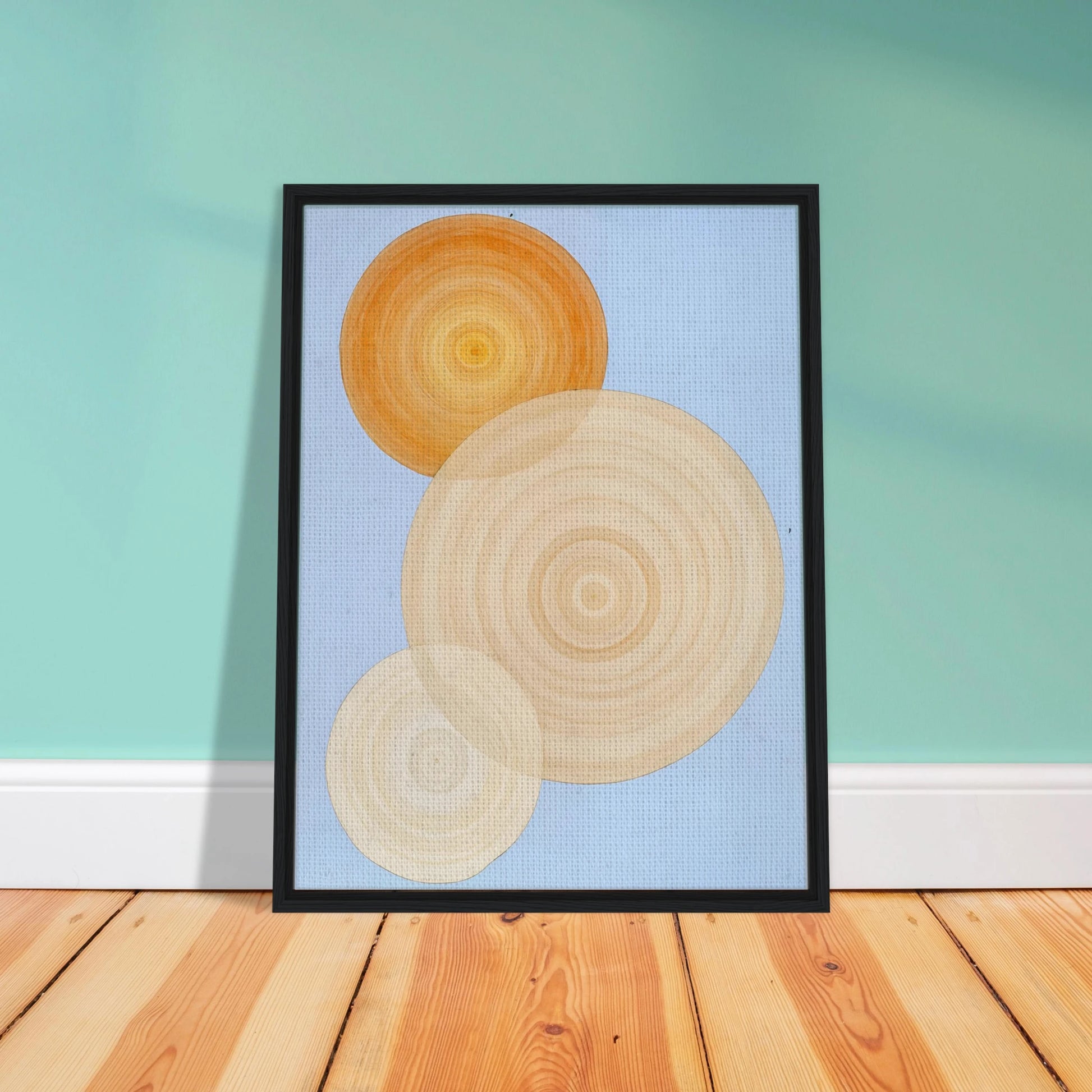 Three overlapping concentric circles in warm orange and beige tones float on a soft blue background like suns in serene orbit.