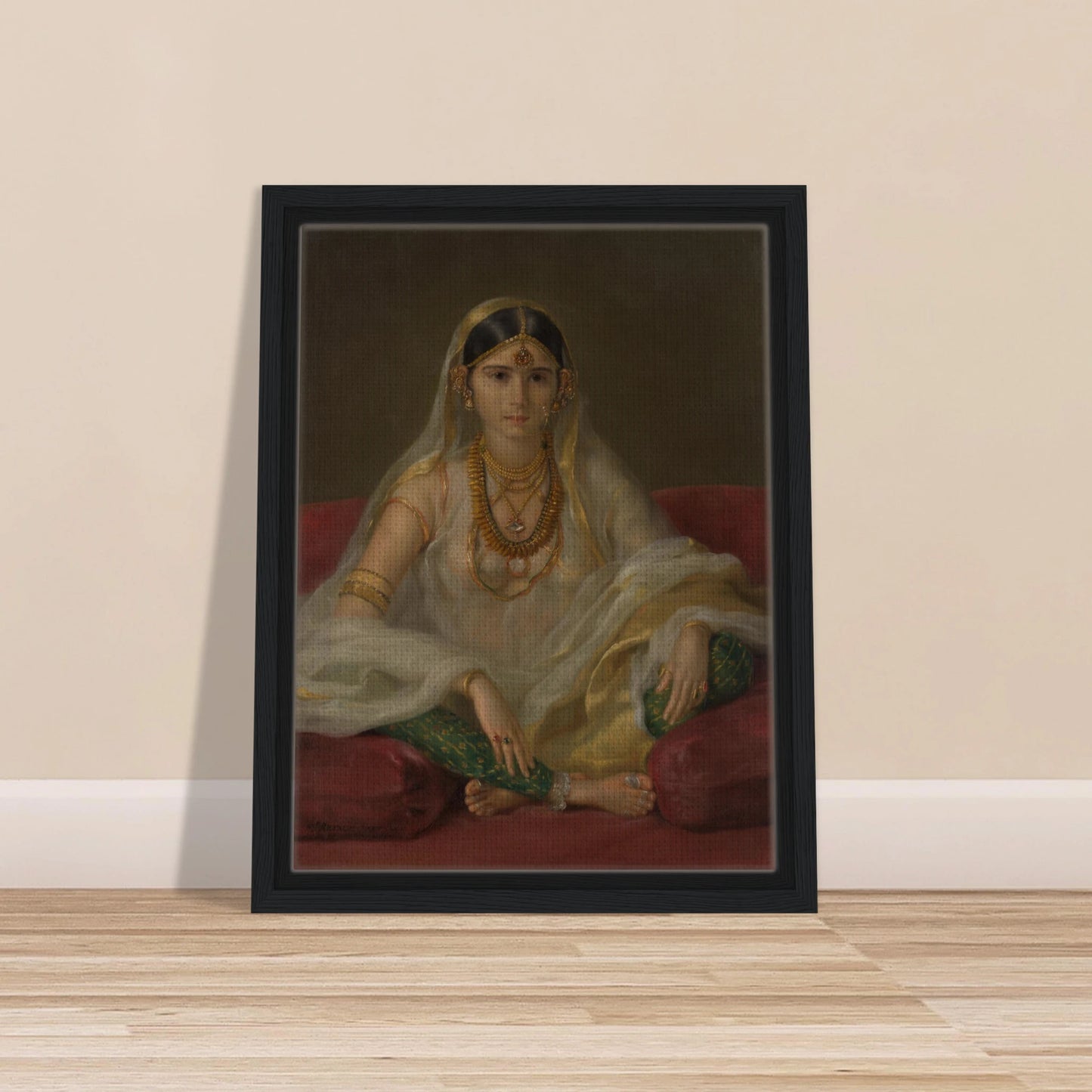 A Mughal woman in a sheer white veil and gold jewelry sits cross-legged on deep red cushions.
