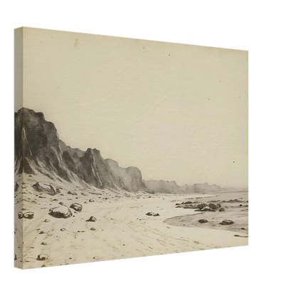 Minimal coastal landscape with pale sandy shore, rugged cliffs, scattered stones, and calm sea rendered in soft monochrome tones.