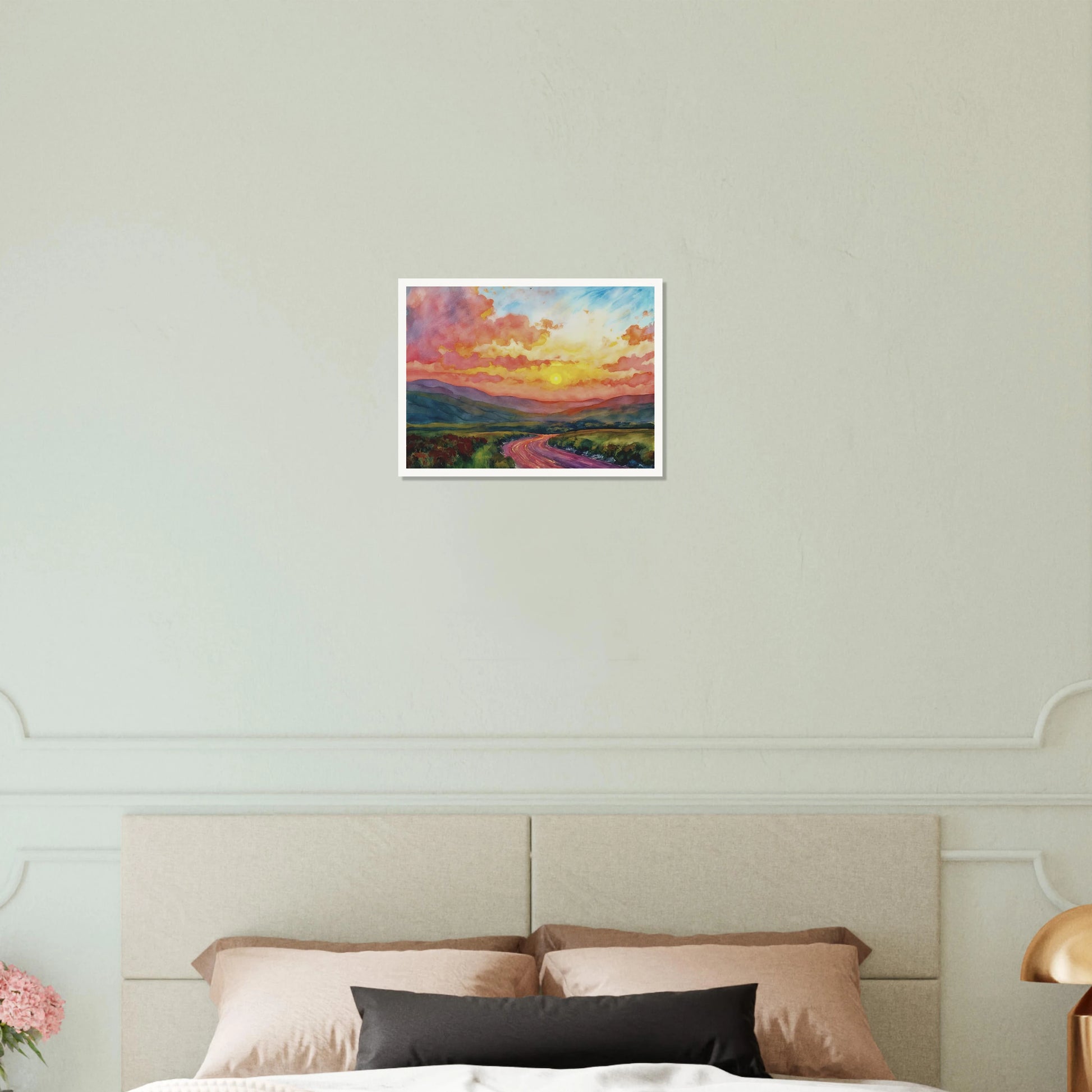 Vibrant watercolor landscape of a winding road through rolling hills beneath a glowing sunset sky filled with pink, gold, and blue clouds.