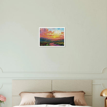 Vibrant watercolor landscape of a winding road through rolling hills beneath a glowing sunset sky filled with pink, gold, and blue clouds.