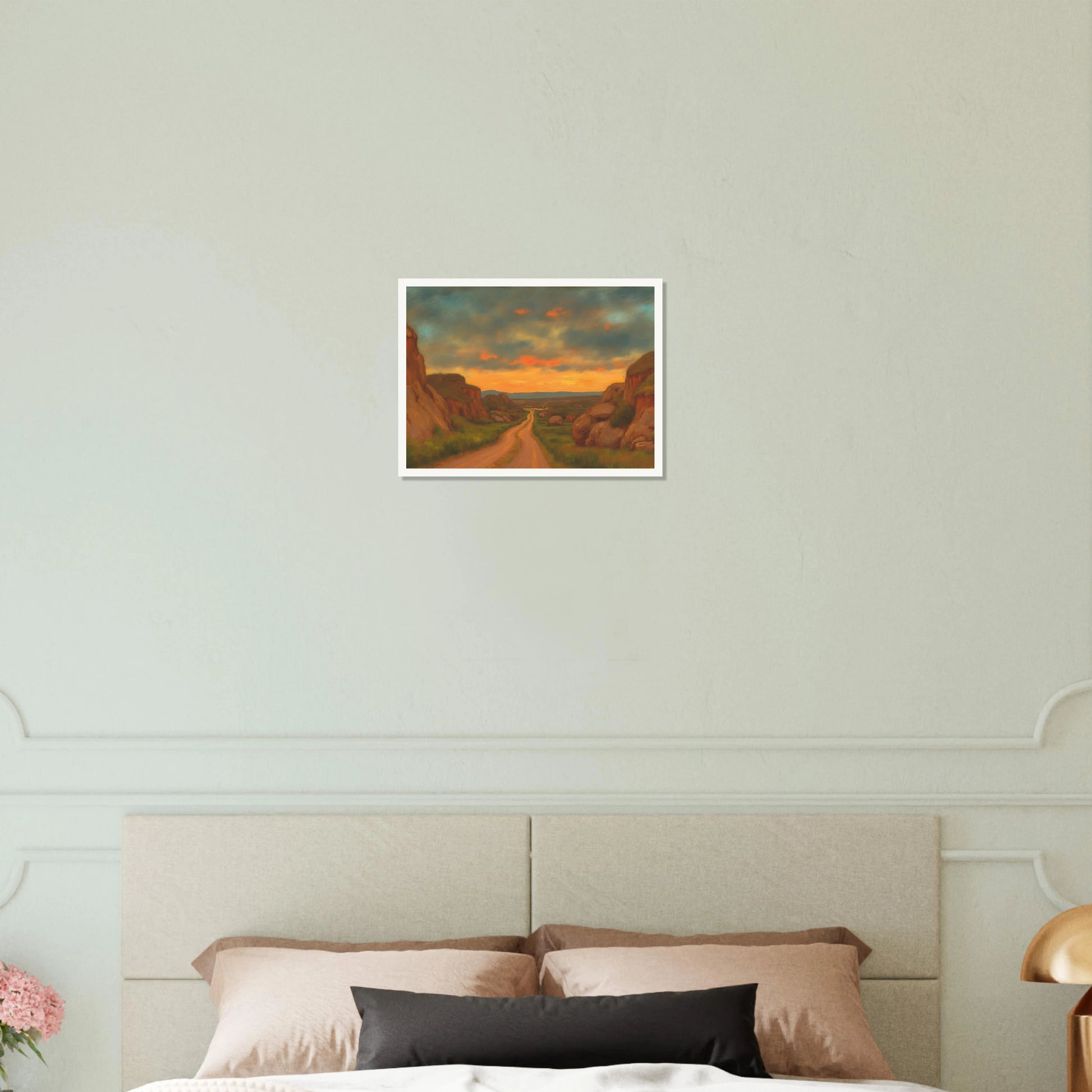 A winding dirt road cuts through rocky hills under a glowing sunset sky, evoking peace, wanderlust, and quiet reflection.