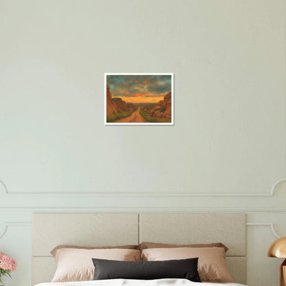 A winding dirt road cuts through rocky hills under a glowing sunset sky, evoking peace, wanderlust, and quiet reflection.