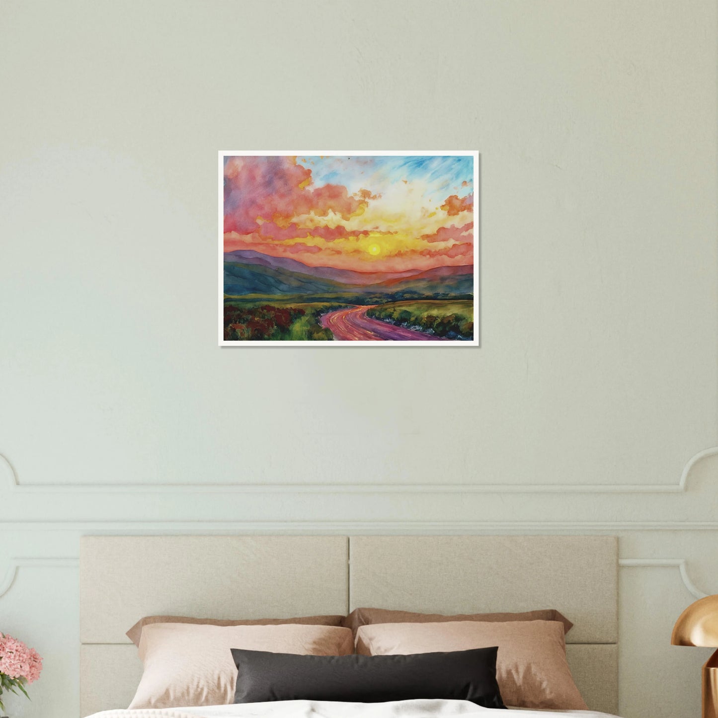 Vibrant watercolor landscape of a winding road through rolling hills beneath a glowing sunset sky filled with pink, gold, and blue clouds.